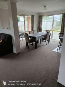 a living room with a dining room table and chairs at Methven Crash Pad in Methven