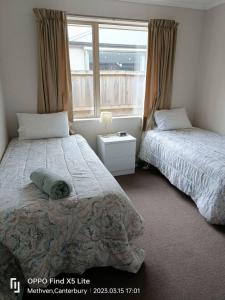 a bedroom with two beds and a window at Methven Crash Pad in Methven