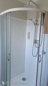 a shower with a glass door in a bathroom at Methven Crash Pad in Methven +22 photos