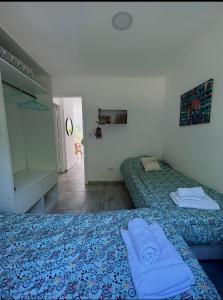 a bedroom with two beds with towels on them at Casa Boutique de la Sierra in Sierra de los Padres +42 photos