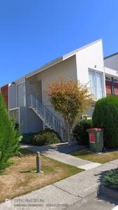 a building with stairs and a trash can in front of it at Mt Hutt Studio at 23 Methven in Methven