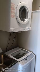 a washer and dryer is under a microwave at Mt Hutt Studio at 23 Methven in Methven +16 photos