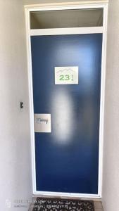 a blue door with a sign on it at Mt Hutt Studio at 23 Methven in Methven