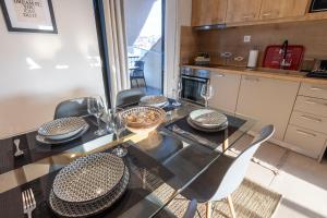a dining room with a glass table and chairs at Atticview Oropos in Néa Palátia