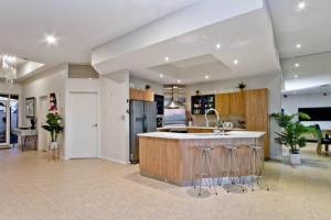 a large kitchen with a sink and a counter at Oceanfront Oasis in Grange