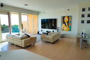 a large living room with two couches and a table at Oceanfront Oasis in Grange