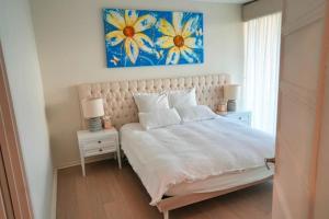 a bedroom with a bed with a painting on the wall at Oceanfront Oasis in Grange