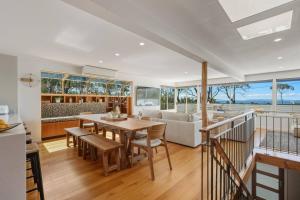 a kitchen and living room with a table and a couch at Bunkers at Seven Mile in Seven Mile Beach