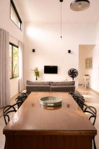 a living room with a table and a couch at Casa Telhado Inclinado in Saquarema