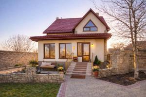 a small white house with a brick wall at Апартаменты in Vinnytsya