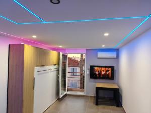 a kitchen with purple lights on the ceiling at l'Oracle Albinos in Nîmes