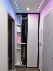a room with a walk in closet with a blue light at l'Oracle Albinos in Nîmes
