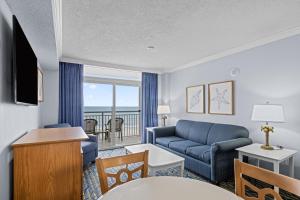 a living room with a couch and a table at Paradise Resort in Myrtle Beach