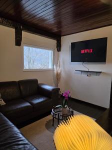 a living room with a couch and a tv at Kuća za odmor Elena in Vrlika