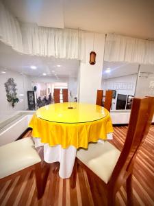 a yellow table and chairs in a room with a kitchen at HOTEL IBYZA Ipiales in Ipiales +19 photos