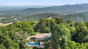an aerial view of a house in the woods at Asher by AvantStay in Asheville