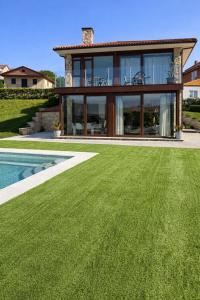 a house with a lawn in front of it at CESANTES VILLAGE e in Pontevedra