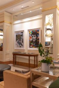 a living room with a table and pictures on the wall at Conrad Indianapolis in Indianapolis +127 photos