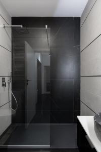 a shower with a glass door in a bathroom at The Signature by D'or Selection in Bucharest