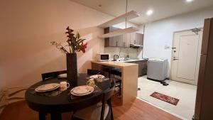 a small kitchen with a table and chairs and a kitchen with a kitchen at park view Service Apartment near KLCC in Kuala Lumpur