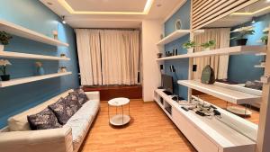 a living room with a couch and a tv at park view Service Apartment near KLCC in Kuala Lumpur