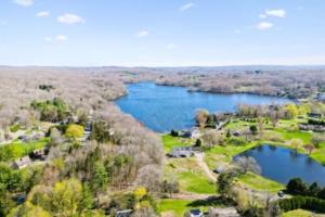 an aerial view of a lake with a house at The Cottage Inn At Amos Lake in Preston