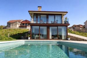 a house with a swimming pool in front of a house at CESANTES VILLAGE e in Pontevedra