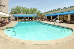 a large swimming pool in the middle of a building at Hilton Jackson in Jackson