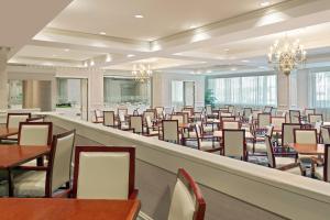a large dining room with tables and chairs at Hilton Jackson in Jackson