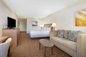 a hotel room with a couch and a bed at Hilton Jackson in Jackson