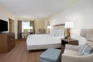 a large hotel room with a bed and a tv at Hilton Jackson in Jackson +44 photos
