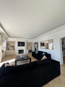 a living room with two couches and a table at La Villa in Sainte-Maxime