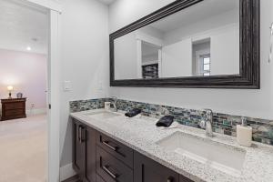 a bathroom with two sinks and a mirror at Hearthside Estate in Prince George +40 photos