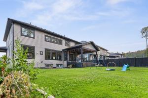 a house with a playground in the yard at Hearthside Estate in Prince George