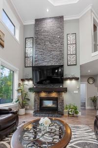 a living room with a fireplace and a couch at Hearthside Estate in Prince George