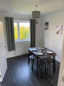 a dining room with a table and a window at Rowe Terrace Workington in Workington +6 photos