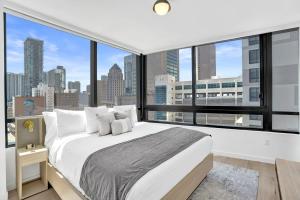 a bedroom with a large white bed with a large window at Miami Condo 2BR Rooftop Pool & Gym in Miami
