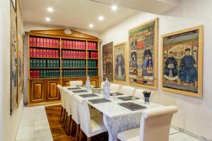 ein Esszimmer mit einem langen Tisch und weißen Stühlen in der Unterkunft Arcom Palace in Pomezia + 98 Fotos