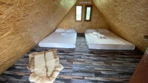 two beds in a small room with a roof at La Nuci in Valea scheilor