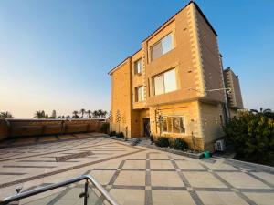 a building with a large courtyard in front of it at فيلا دريم in Sphinx International Airport