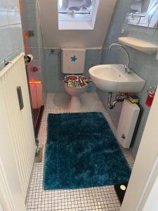 a small bathroom with a toilet and a sink at ANCiENT CiTY WALL in Nuremberg