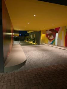 a room with a hallway with colorful walls at Ouro Motel in Sepetiba