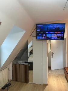 a living room with a flat screen tv on a ceiling at ANCiENT CiTY WALL in Nuremberg