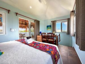 a bedroom with a bed and a table and chairs at Casa Sonoma - Charming Condos Minutes from Beach & Reef in Puerto Morelos +75 photos