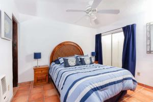 a bedroom with a bed and a ceiling fan at Beautiful Beachfront Condo Olas I 16 in Puerto Peñasco
