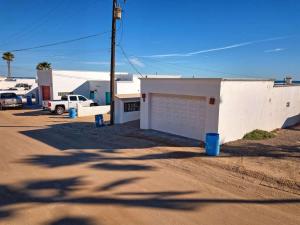 a parking lot with a white building and a street at Beautiful Beachfront Condo Olas I 16 in Puerto Peñasco