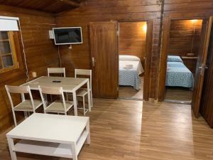 a room with a table and a bed and a tv at Pueblos blancos in Vejer de la Frontera +128 photos