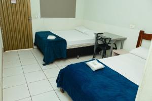 a hospital room with two beds and a table at Lagos Hotel in Itajubá