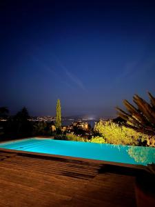 a swimming pool at night with a view at La Villa in Sainte-Maxime