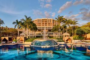 a resort with a fountain in front of a building at Grand Wailea Resort Hotel & Spa, A Waldorf Astoria Resort in Wailea